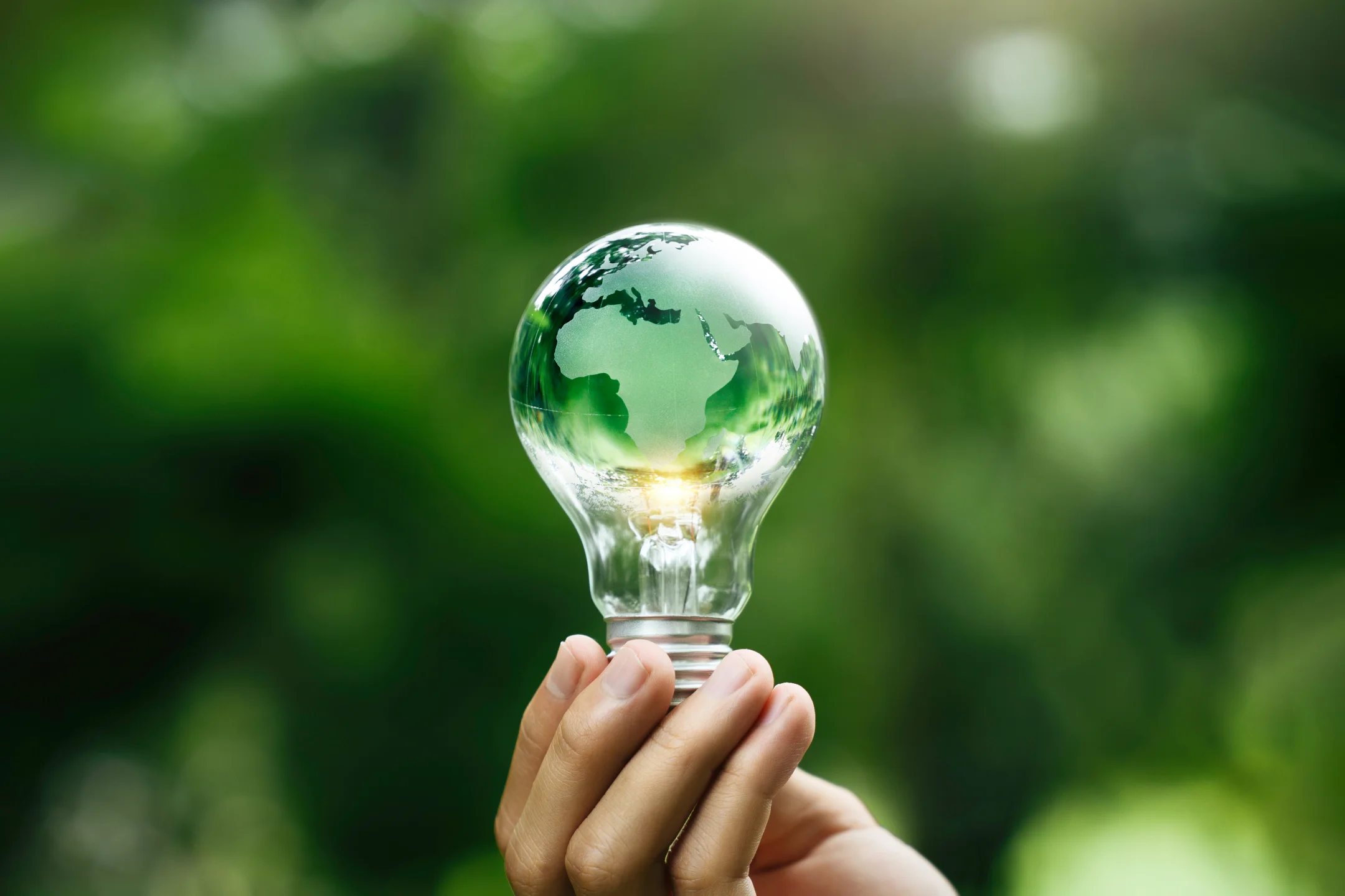 Lamp with a map of the world drawn on the glass held in a hand